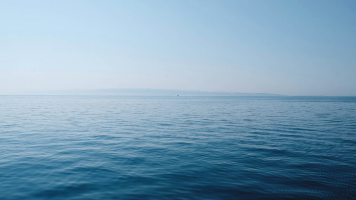Calm, clear tropical sea under a blue sky during Tioman's dive season