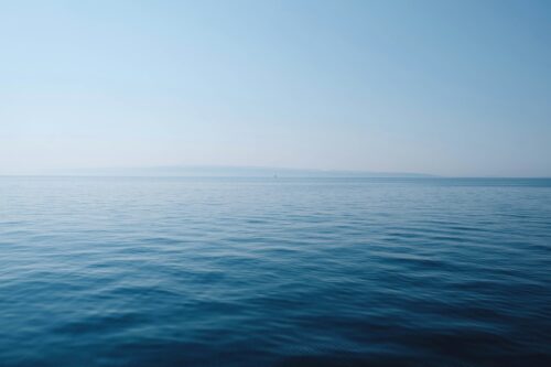 Calm, clear tropical sea under a blue sky during Tioman's dive season