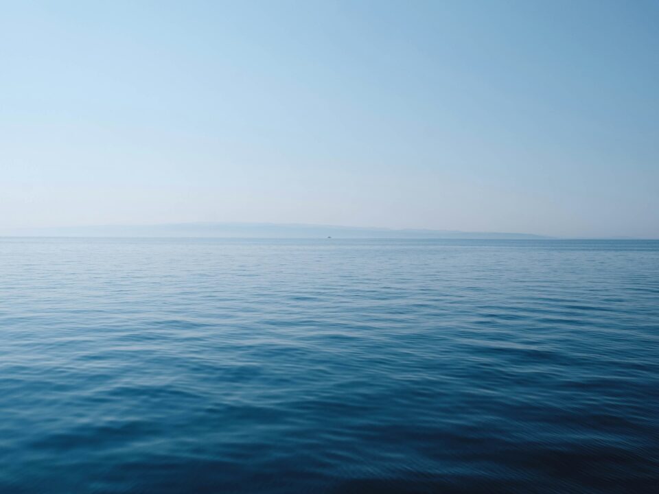 Calm, clear tropical sea under a blue sky during Tioman's dive season