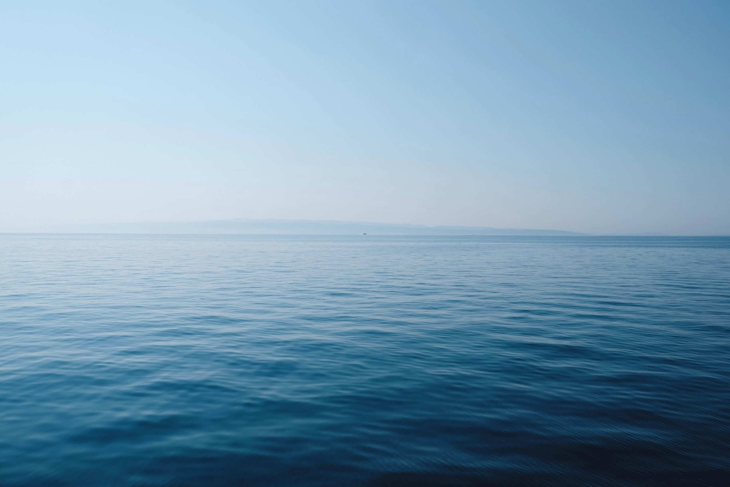 Calm, clear tropical sea under a blue sky during Tioman's dive season