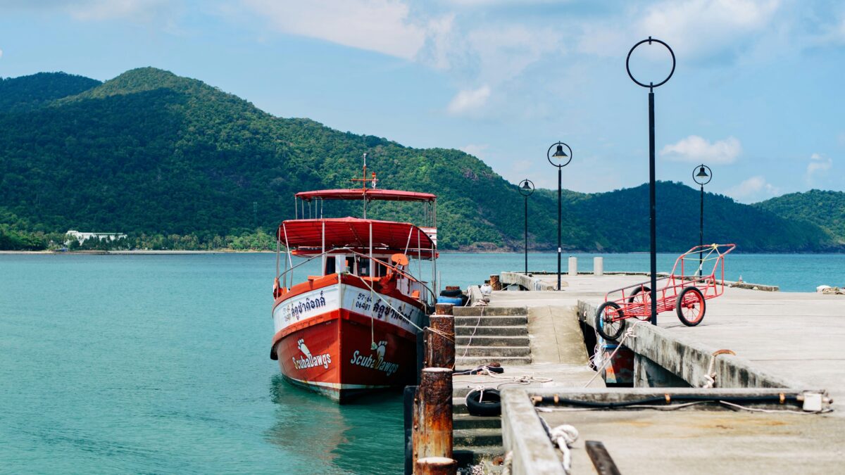 Ferry approaching a tropical island jetty like Kampung Genting on Tioman