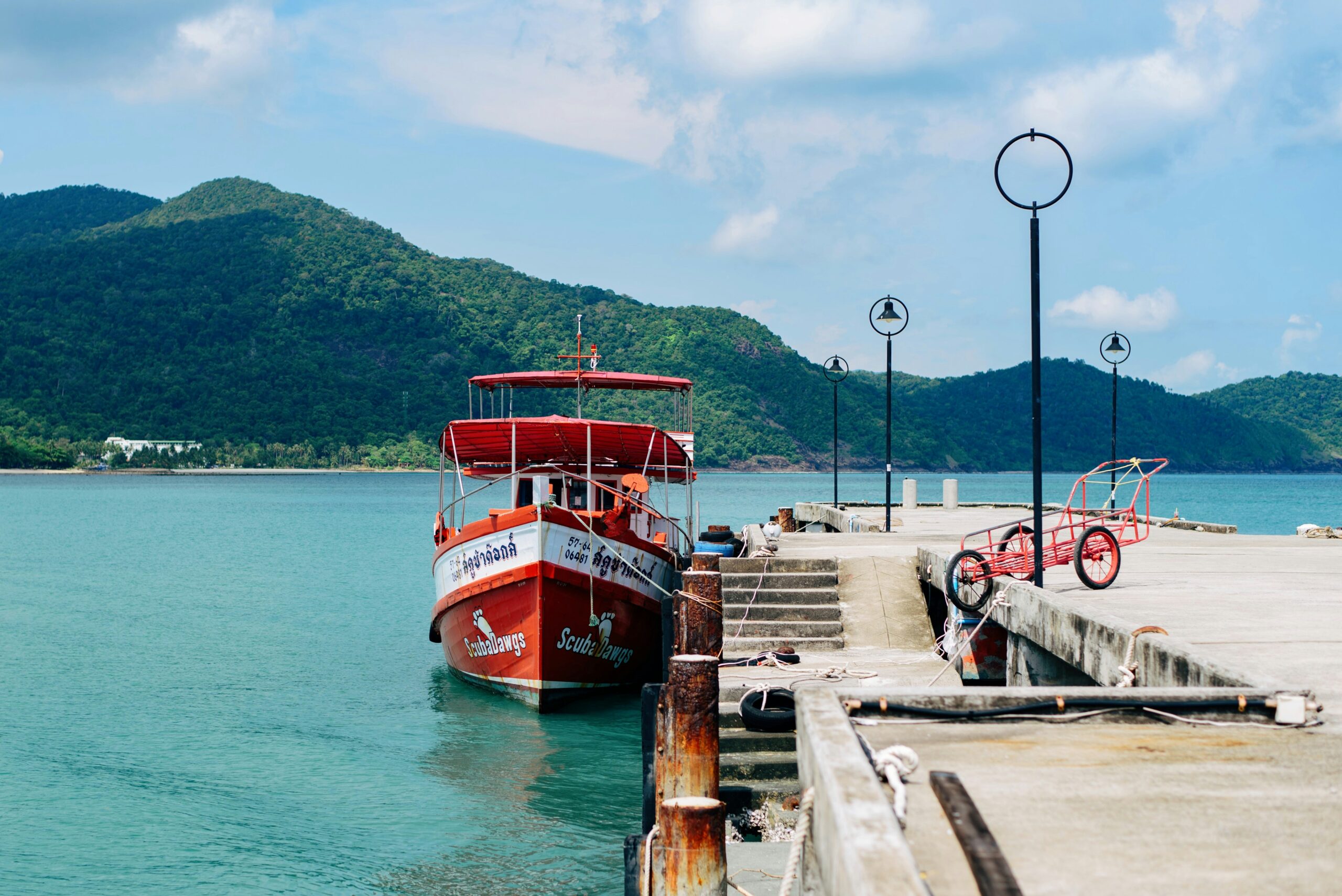 Ferry approaching a tropical island jetty like Kampung Genting on Tioman
