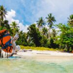 Solo traveler on a tropical island beach like Tioman